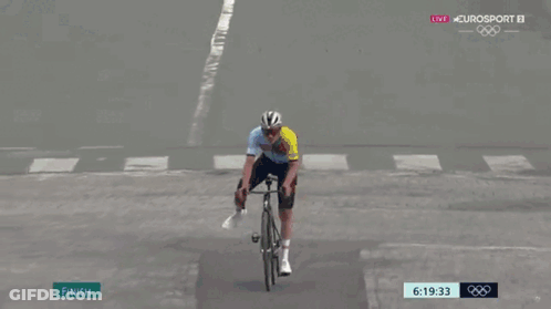 A Person Riding A Bike Across A Finish Line With Omega Written On The Bottom GIF