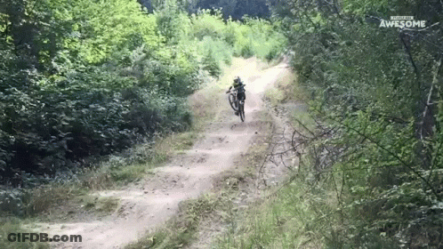 A Person Riding A Bike Down A Dirt Road With The Words Awesome Written On The Bottom GIF