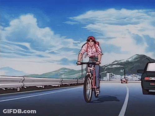A Person Riding A Bike On A Road With A Car Behind Them GIF