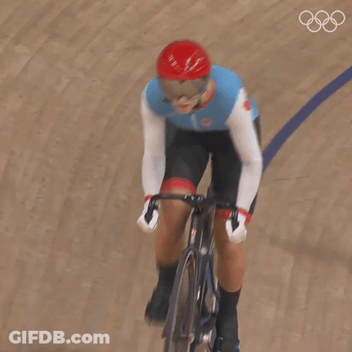 A Person Riding A Bike On A Track With The Number 1 On Their Shirt GIF