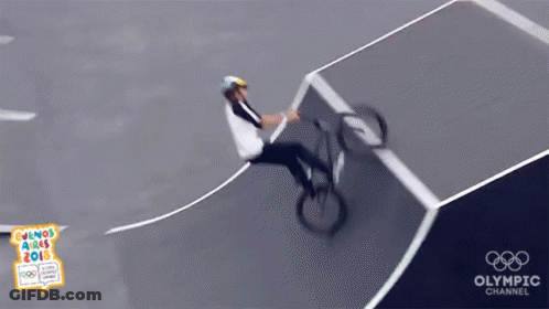 A Person Riding A Bike On A Track With The Olympic Channel Logo GIF