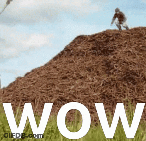 A Person Riding A Bike On Top Of A Pile Of Hay GIF