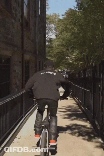 A Person Riding A Bike With The Word Route On The Back Of Their Shirt GIF