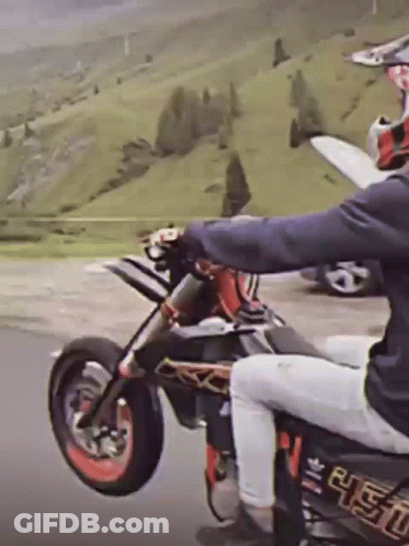 A Person Riding A Dirt Bike With A Sticker On The Back That Says ' R.e.t.o. ' GIF