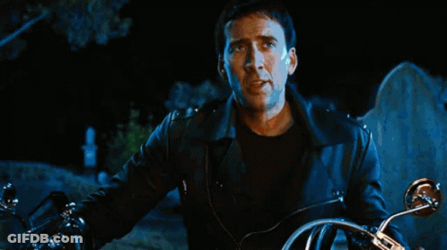 A Person Riding A Motorcycle In Front Of A Large Fire GIF