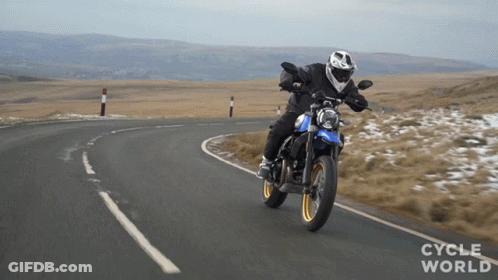 A Person Riding A Motorcycle On A Road With The Words Cycle World Visible GIF