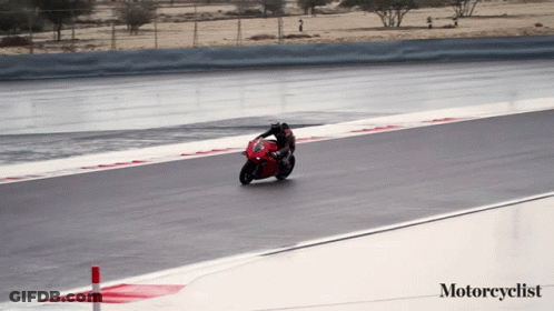 A Person Riding A Red Motorcycle On A Track With The Words Motorcyclist Below Them GIF