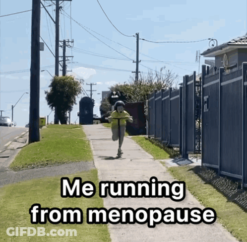 A Person Riding A Scooter Down A Sidewalk With The Words Me Running From Menopause GIF
