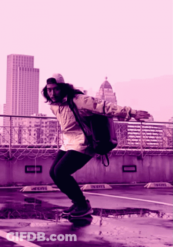 A Person Riding A Skateboard In A Parking Lot With A Sign That Says ' Taxi ' On It GIF