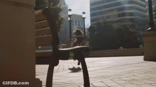 A Person Riding A Skateboard In Front Of A Building That Says ' A & T ' On It GIF