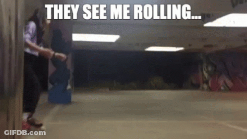A Person Rollerblading In A Hallway With The Words They See Me Rolling Above Them GIF