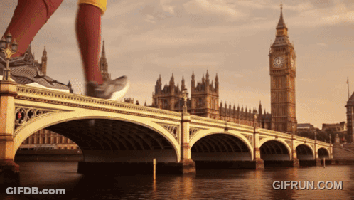 A Person Running On A Bridge With A Big Ben In The Background GIF