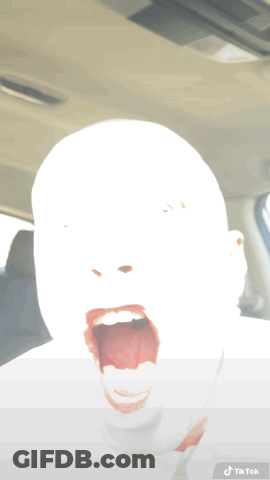 A Person 'S Face Is Visible In A Car With A Tiktok Sticker On The Bottom GIF