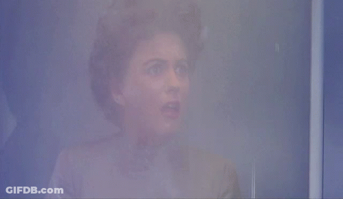 A Person 'S Face Is Visible In A Foggy Room In A Blurry Photo GIF