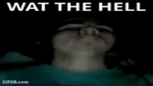 A Person 'S Face Is Visible In The Dark With The Words Wat The Hell Written On It . GIF
