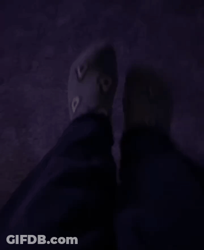 A Person 'S Feet Are Shown In A Dark Room With A Purple Carpet GIF