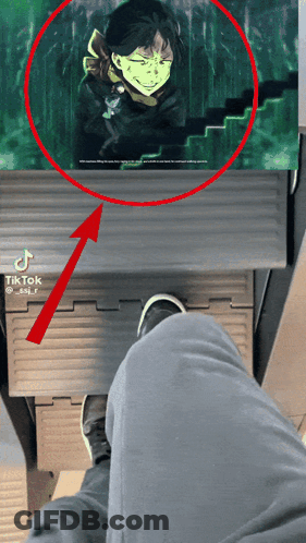 A Person 'S Feet Are Shown In Front Of A Picture Of A Man With A Mask On His Face GIF