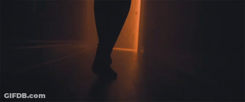 A Person 'S Feet Are Shown Walking Through A Doorway GIF