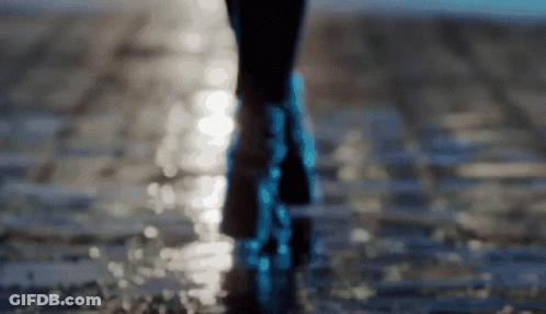 A Person 'S Feet Are Visible In A Blurry Photo As They Walk Through The Water GIF