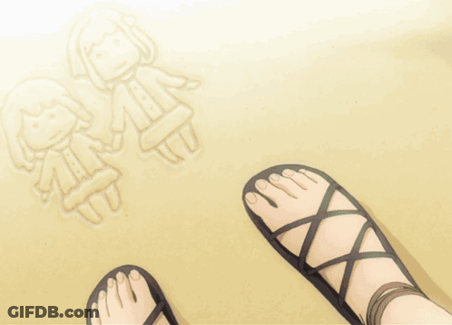 A Person 'S Feet In Sandals On The Beach GIF