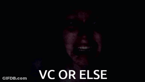 A Person 'S Hand Is Covering Their Face In The Dark With The Words `` Vc Or Else '' . GIF