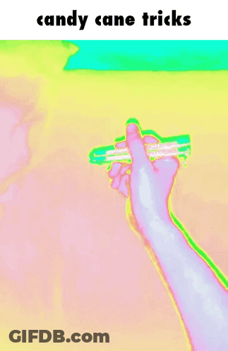 A Person 'S Hand Is Holding A Candy Cane With The Words Candy Cane Tricks Above It GIF