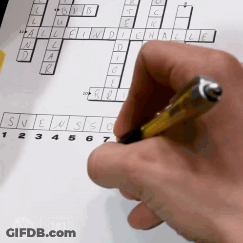 A Person 'S Hand Is Holding A Pen Over A Crossword Puzzle On A Piece Of Paper GIF