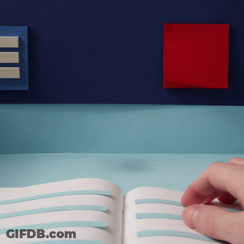 A Person 'S Hand Is Holding An Open Book With Blue Stripes On It GIF