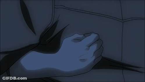 A Person 'S Hand Is On Another Person 'S Chest In A Dark Room GIF
