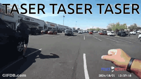 A Person 'S Hand Is Pointing At A Car In A Parking Lot With The Words Taser Taser Taser GIF