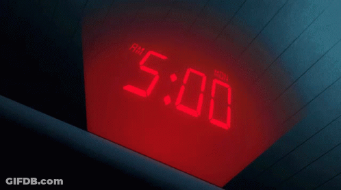A Person 'S Hand Is Pointing At A Digital Clock That Says Am 5:40 GIF