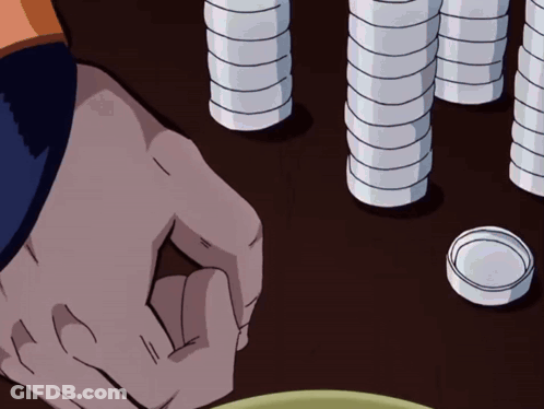 A Person 'S Hand Is Reaching For Something On A Table With Stacks Of Coins In The Background GIF