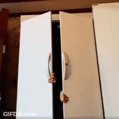 A Person 'S Hand Is Reaching Into A White Refrigerator Door GIF
