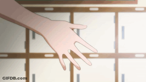 A Person 'S Hand Is Reaching Out In Front Of A Row Of Cabinets GIF