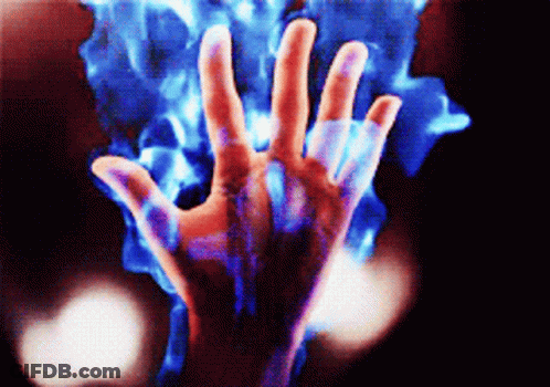 A Person 'S Hand Is Surrounded By A Blue Flame GIF