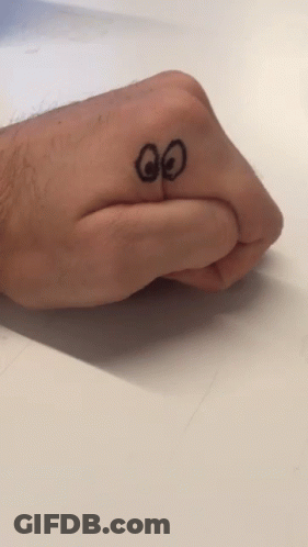 A Person 'S Hand With A Drawing Of A Face On It GIF