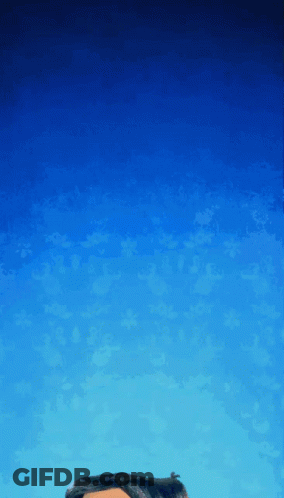 A Person 'S Head Is Against A Blue Sky With Clouds GIF