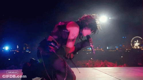 A Person Singing Into A Microphone With The Word Cancella On The Bottom GIF