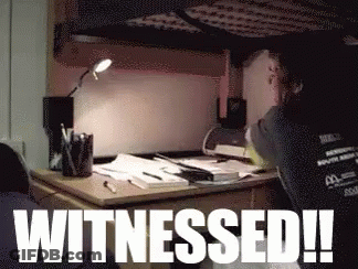 A Person Sitting At A Desk With The Words Witnessed Written On It GIF