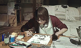 A Person Sitting At A Table With A Piece Of Paper That Says ' I ' On It GIF