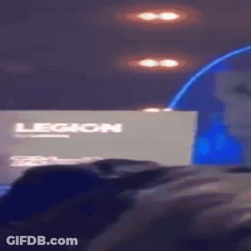 A Person Sitting In Front Of A Legion Sign GIF