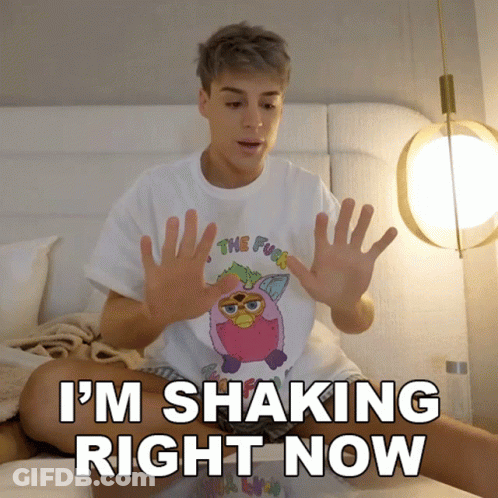 A Person Sitting On A Bed With The Words " I 'M Shaking Right Now " On The Bottom GIF