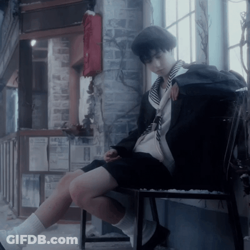 A Person Sitting On A Chair With A Backpack On The Back GIF