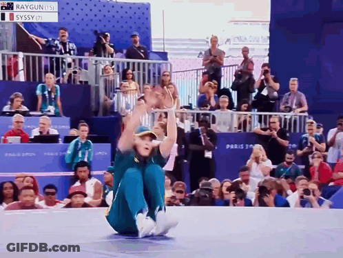 A Person Sitting On The Ground With A Sign That Says Raygun Us On It GIF