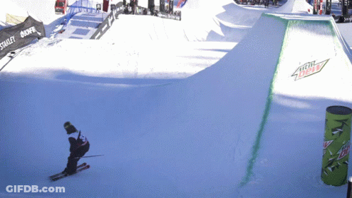 A Person Skiing Down A Snowy Slope With A Mountain Dew Sign On The Side GIF