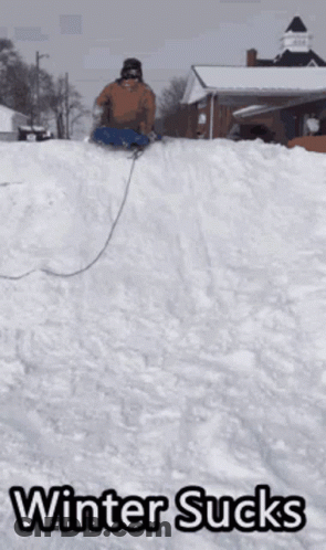 A Person Sledding Down A Snowy Hill With The Words Winter Sucks Written Below Them GIF
