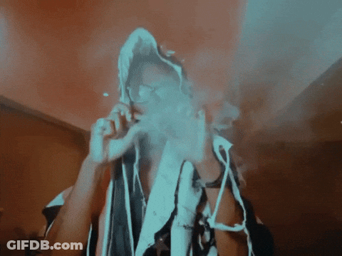 A Person Smoking A Cigarette With A Hood On GIF