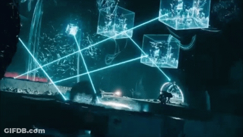 A Person Standing In A Dark Room With A Bunch Of Glowing Boxes In The Background GIF