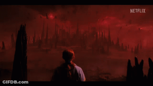 A Person Standing In Front Of A Red Background With Netflix Written On It GIF