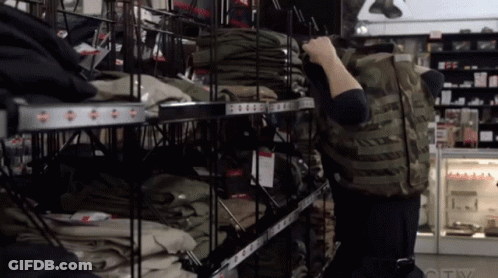 A Person Standing In Front Of A Shelf With Clothes On It That Says Ctv GIF